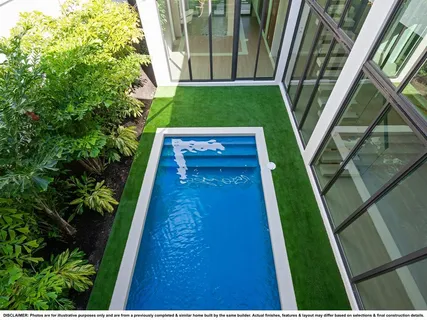 a view of a backyard with plants and large trees