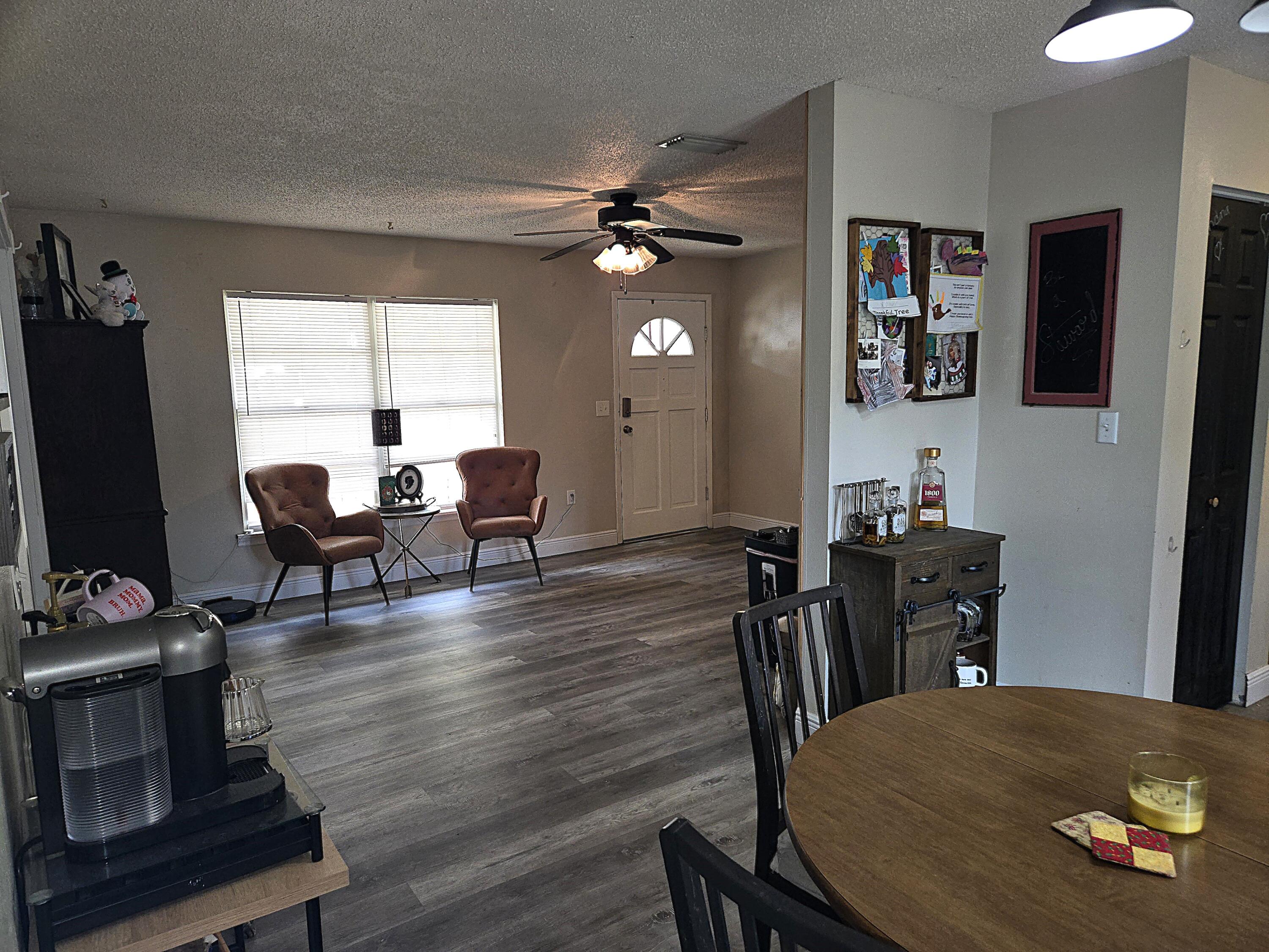211 Northeast 3rd Terrace Williston, FL 32696 - Photo 12 of 46 a view of a dining room with furniture and wooden floor