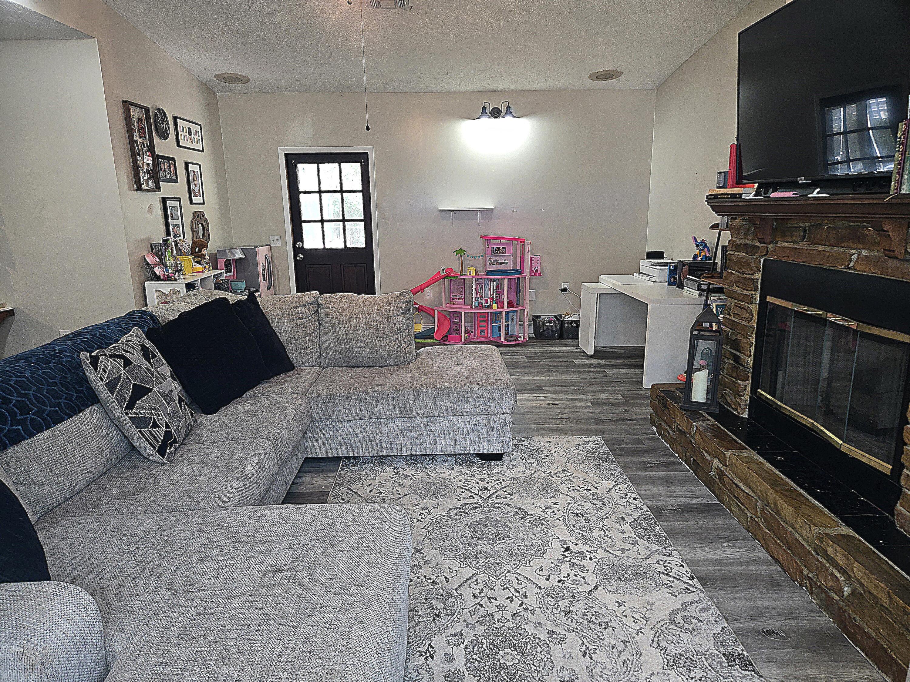 211 Northeast 3rd Terrace Williston, FL 32696 - Photo 22 of 46 a living room with furniture and a fireplace