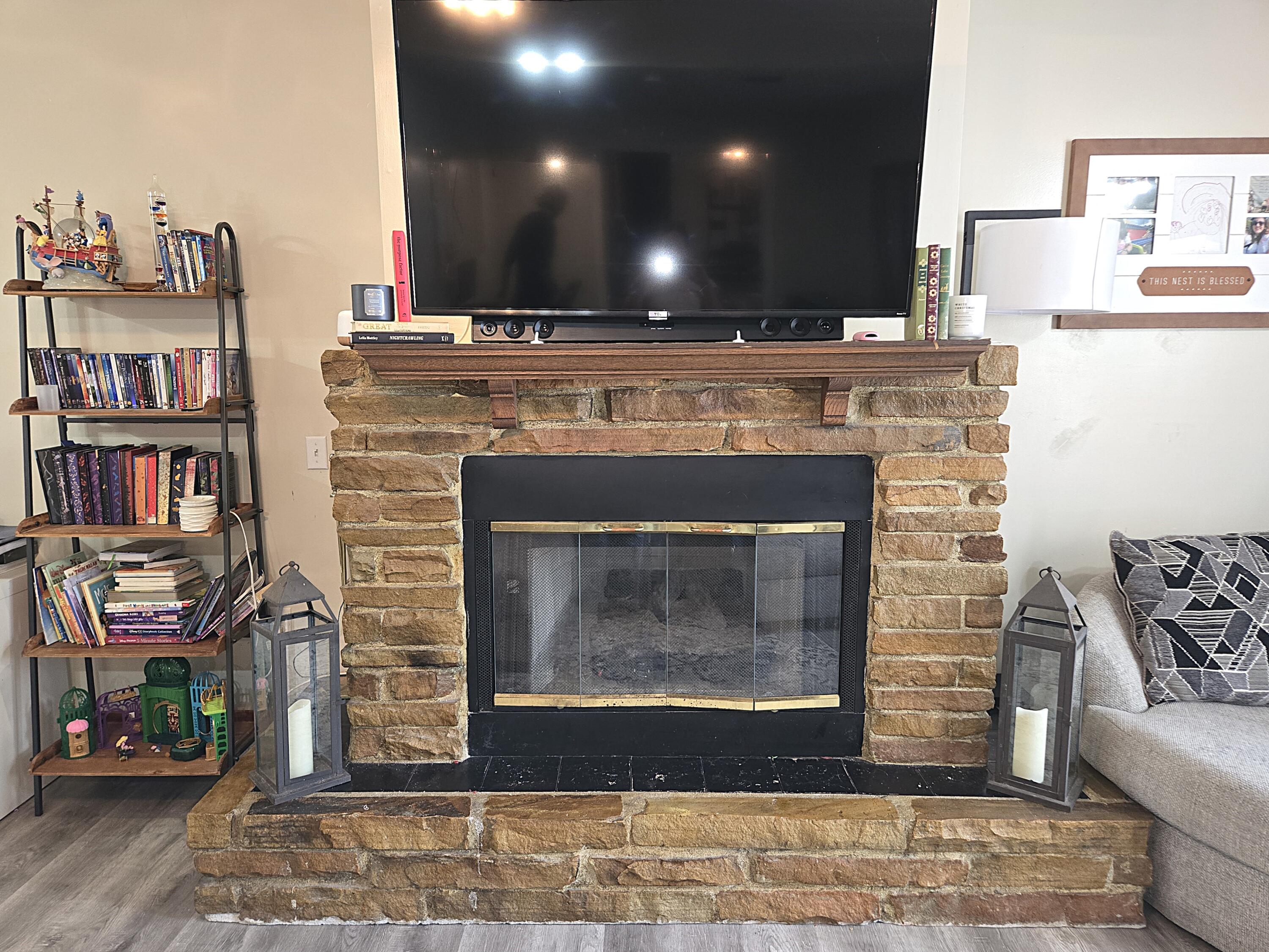 211 Northeast 3rd Terrace Williston, FL 32696 - Photo 24 of 46 a living room with fireplace furniture and a book shelf