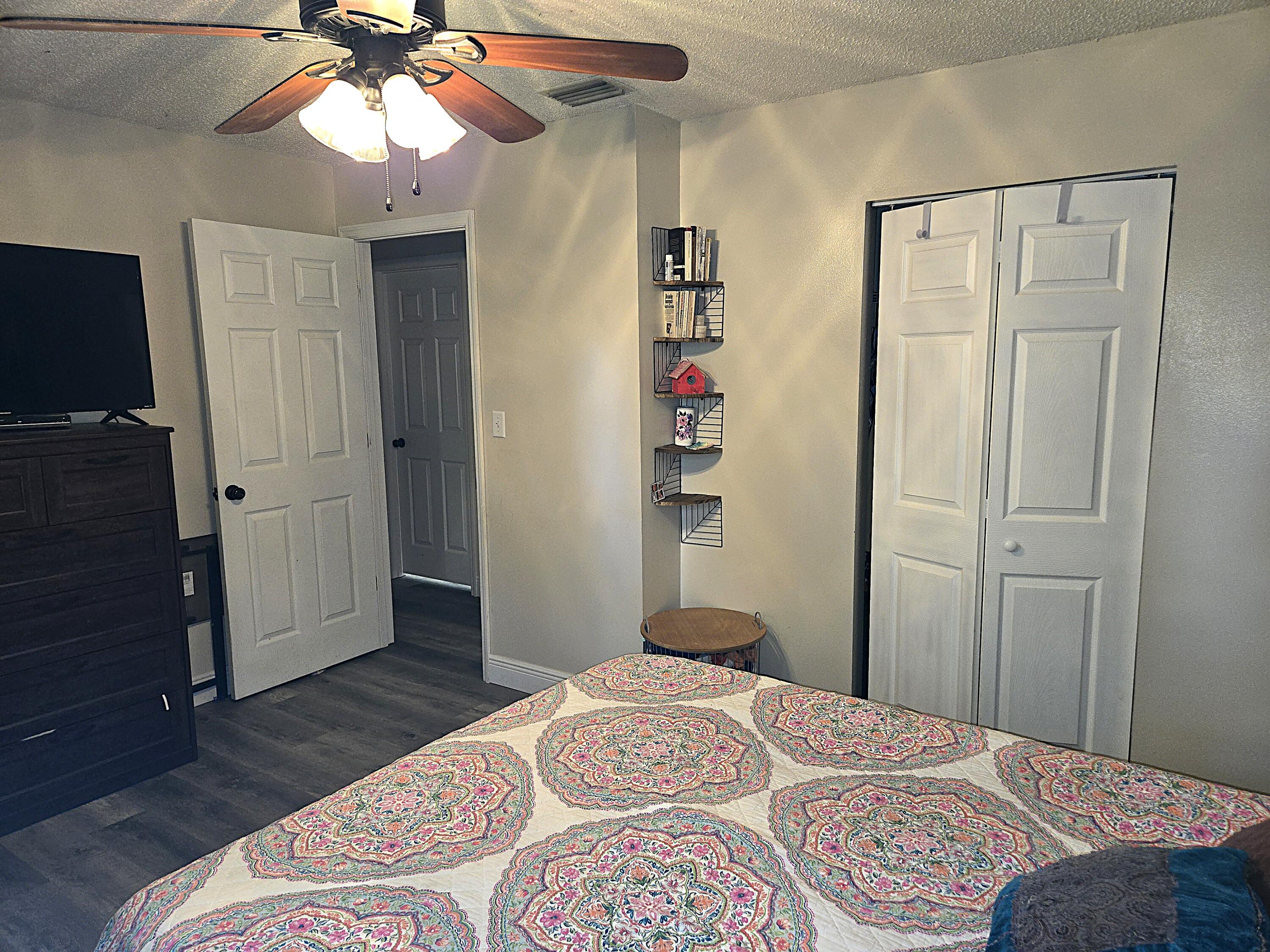 211 Northeast 3rd Terrace Williston, FL 32696 - Photo 29 of 46 a bedroom with a bed and a chandelier