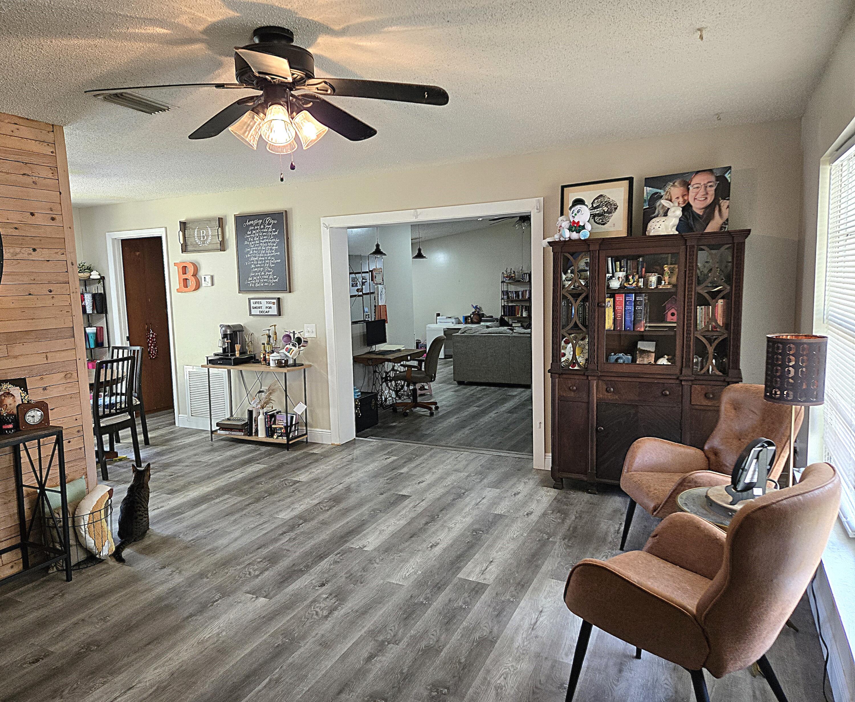 211 Northeast 3rd Terrace Williston, FL 32696 - Photo 3 of 46 a living room with furniture and a wooden floor