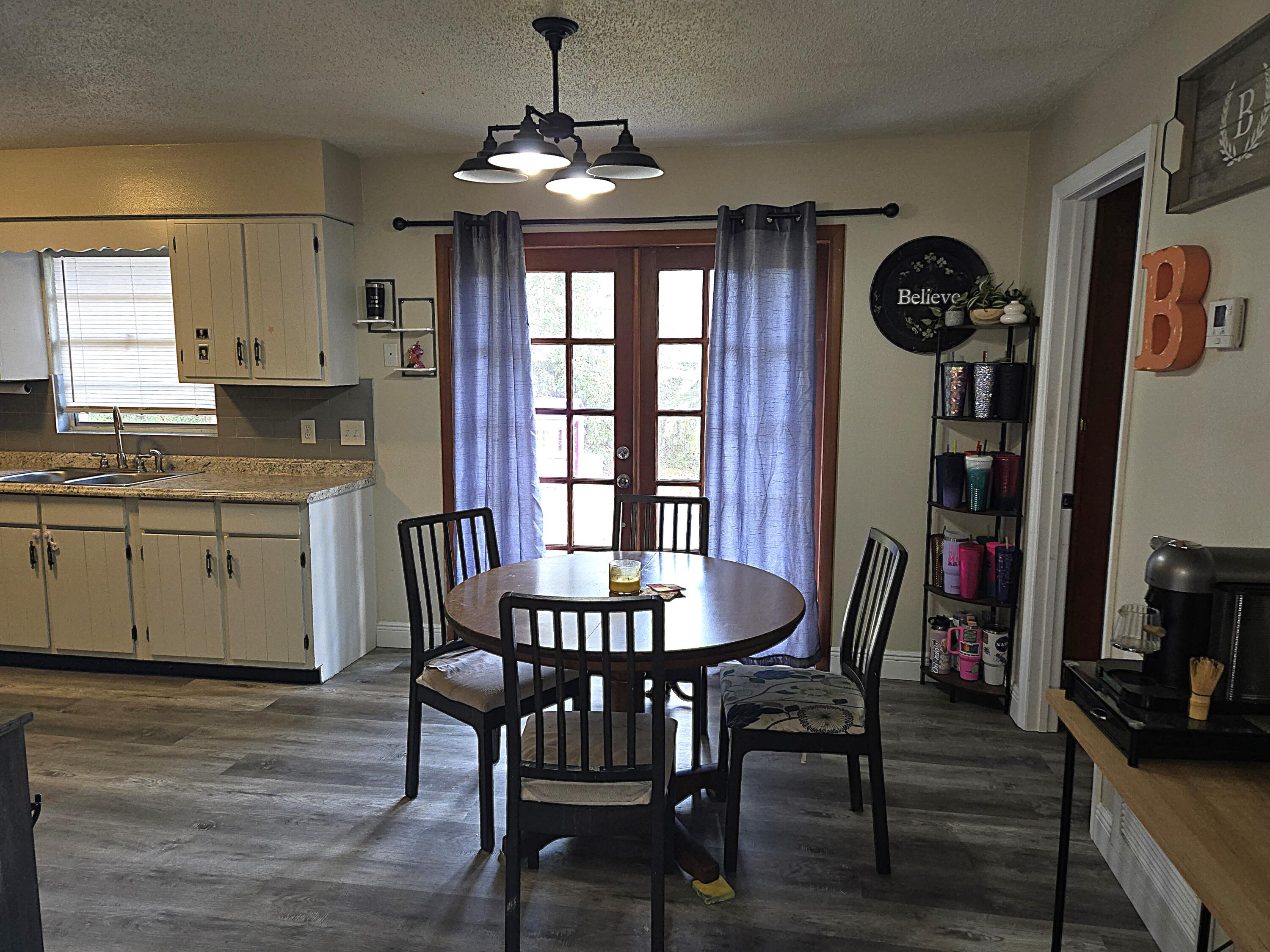211 Northeast 3rd Terrace Williston, FL 32696 - Photo 9 of 46 a view of a dining room with furniture window and wooden floor