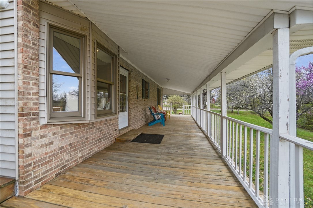7553 Coffin Station Road Springfield, OH 45502 - Photo 88 of 95 Relax on this expansive covered porch, perfect for enjoying peaceful outdoor moments.