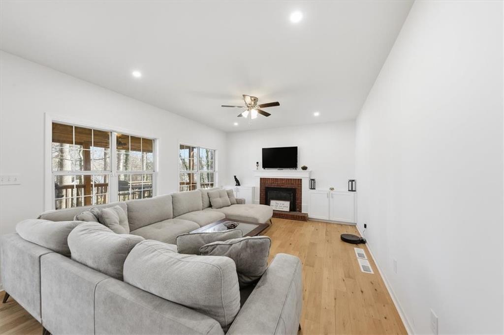 2769 Springfount Trail Northeast Lawrenceville, GA 30043 - Photo 16 of 52 a living room with furniture and a fireplace