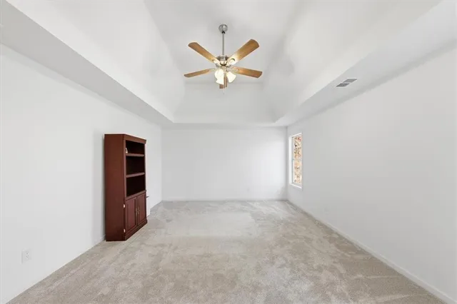 an empty room with closet and windows