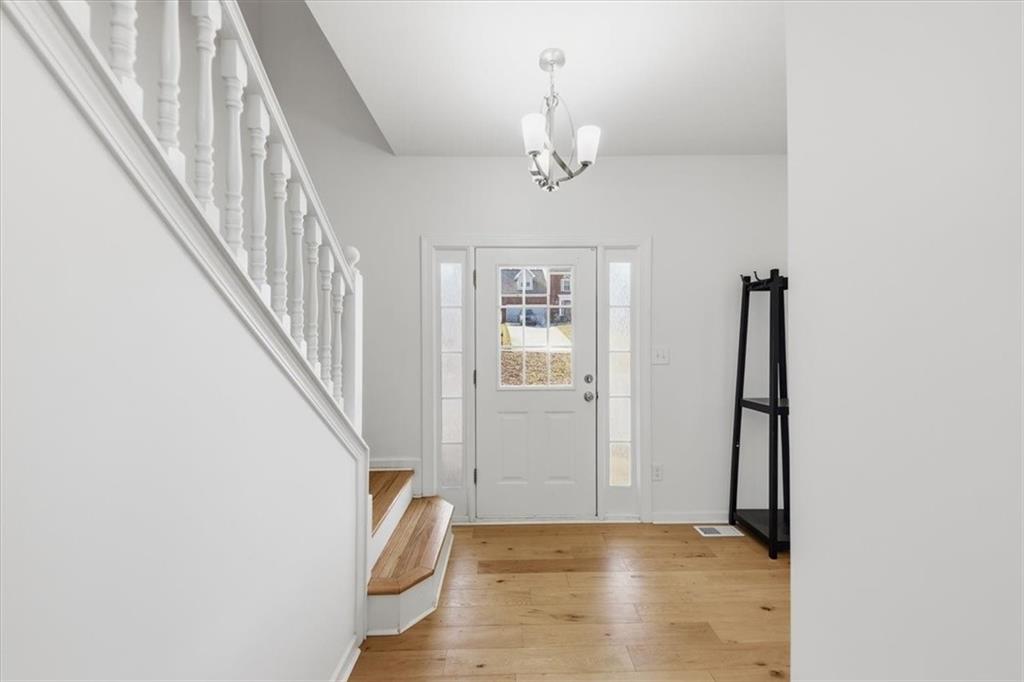 2769 Springfount Trail Northeast Lawrenceville, GA 30043 - Photo 3 of 52 a view of a hallway with wooden floor and staircase