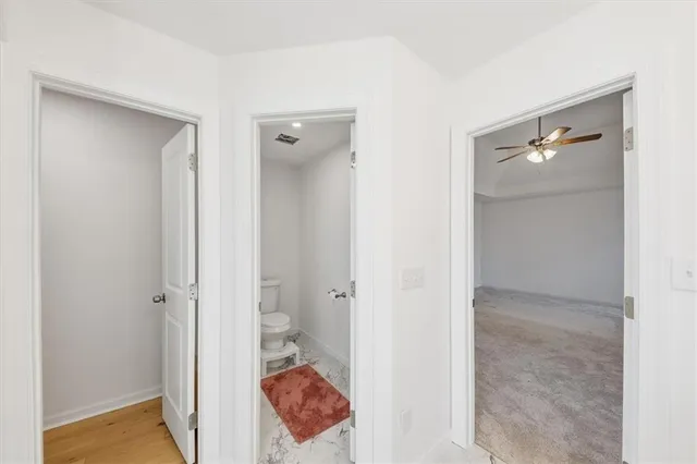 a view of a bathroom from a hallway