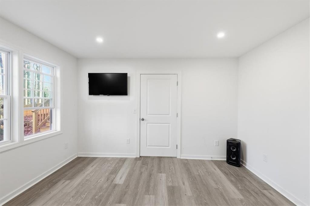 2769 Springfount Trail Northeast Lawrenceville, GA 30043 - Photo 39 of 52 a view of an empty room with wooden floor and a window