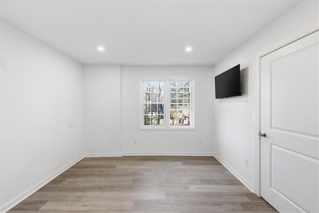 2769 Springfount Trail Northeast Lawrenceville, GA 30043 - Photo 40 of 52 an empty room with wooden floor and windows