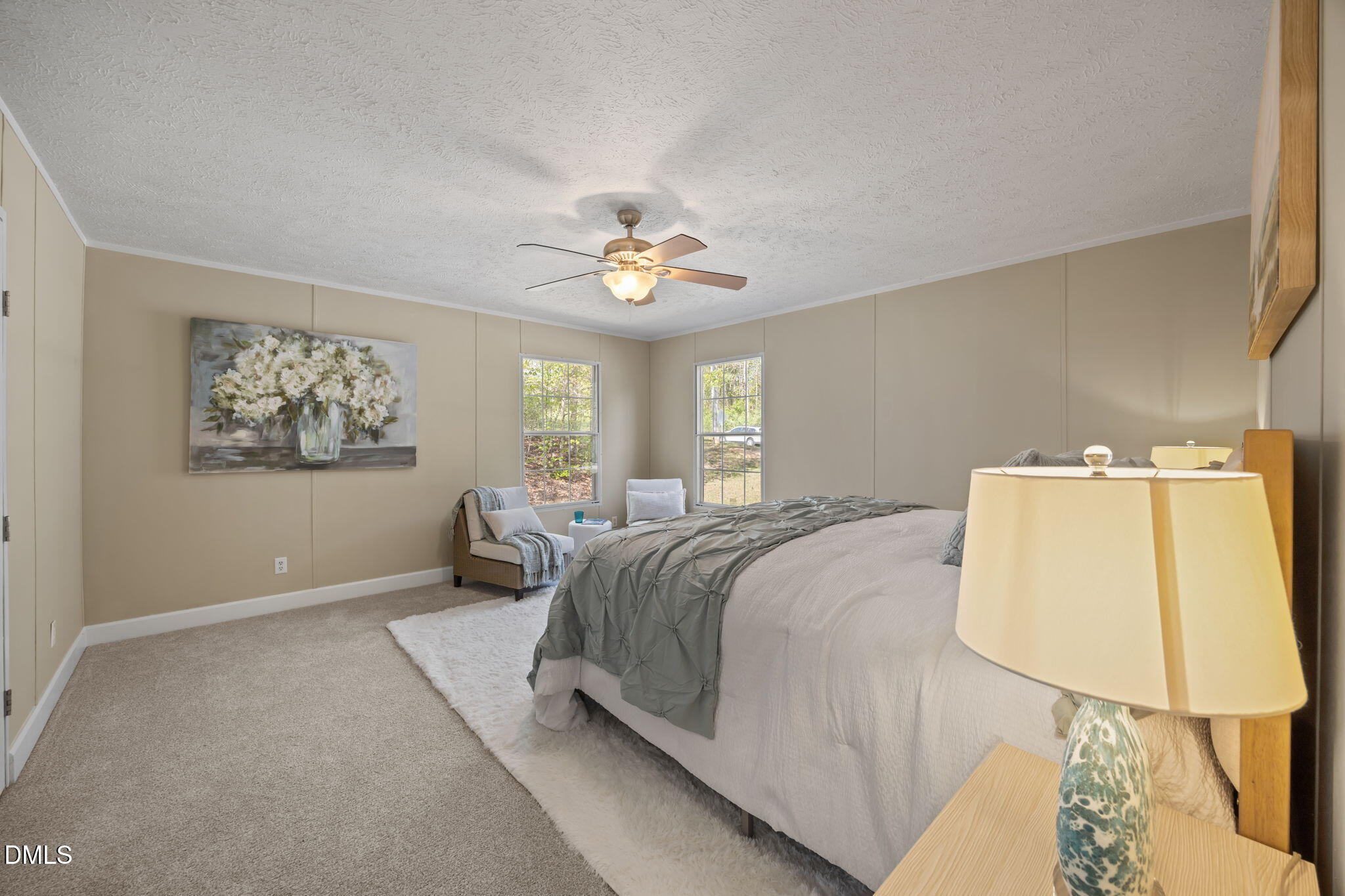 721 General Green Road Kittrell, NC 27544 - Photo 16 of 36 a spacious bedroom with a bed and a chandelier