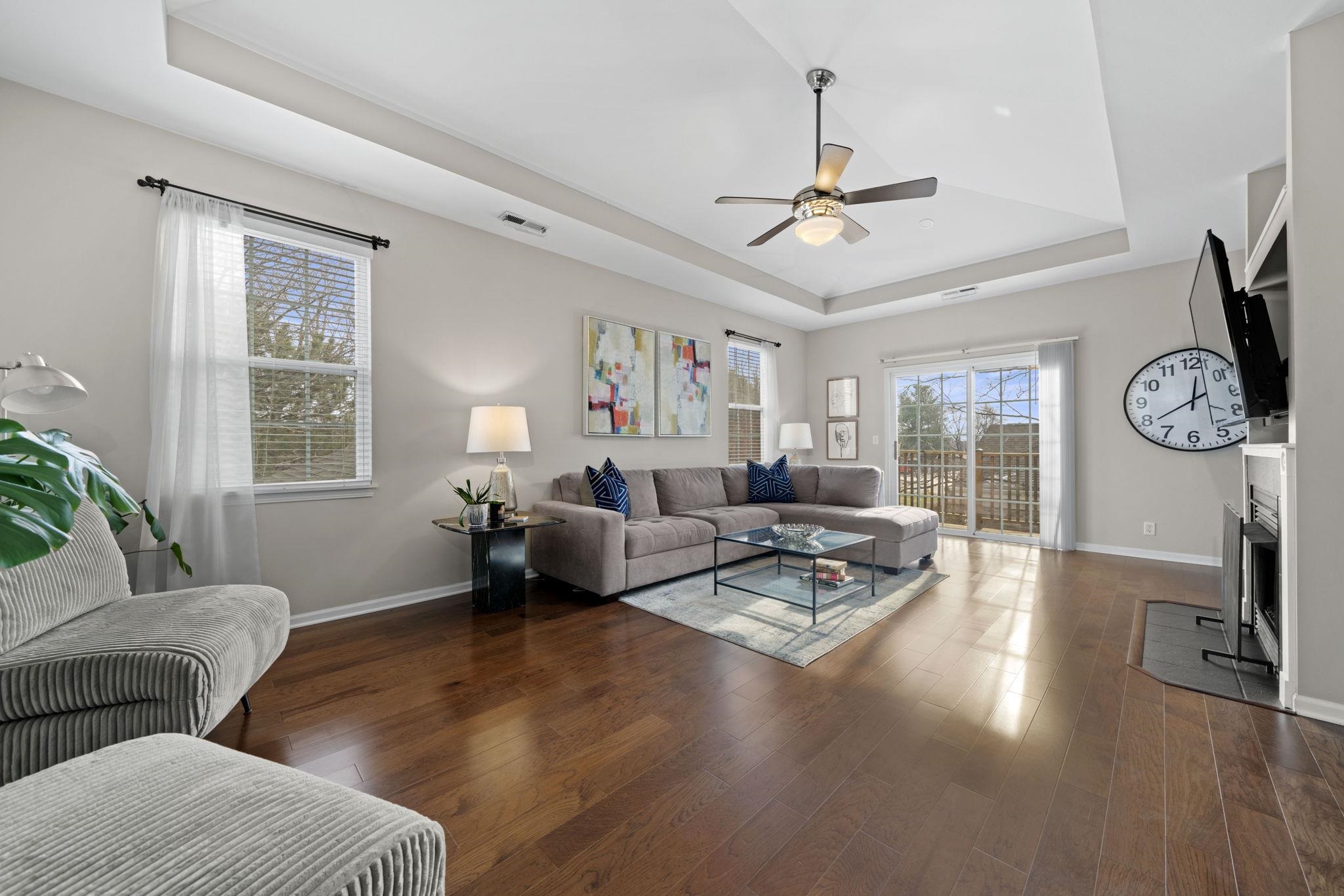 7621 Magnolia Trail Cherry Valley, IL 61016 - Photo 12 of 27 a living room with furniture a chandelier and a window
