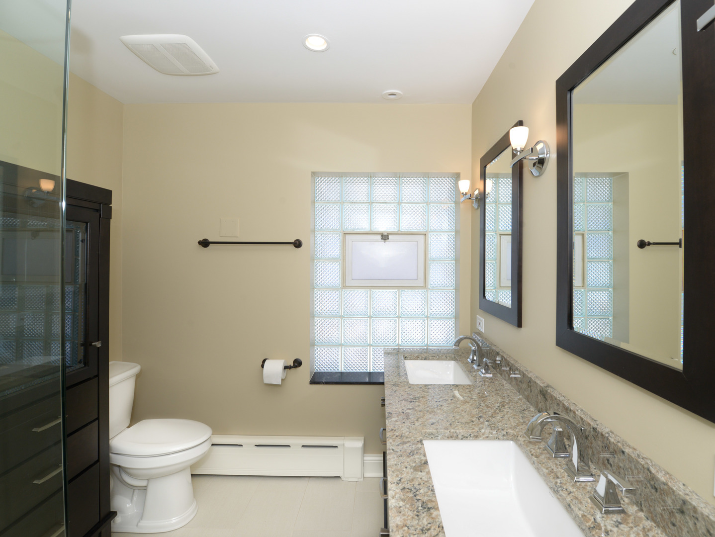 1149 Willow Road Winnetka, IL 60093 - Photo 20 of 37 a bathroom with a granite countertop sink a toilet and shower