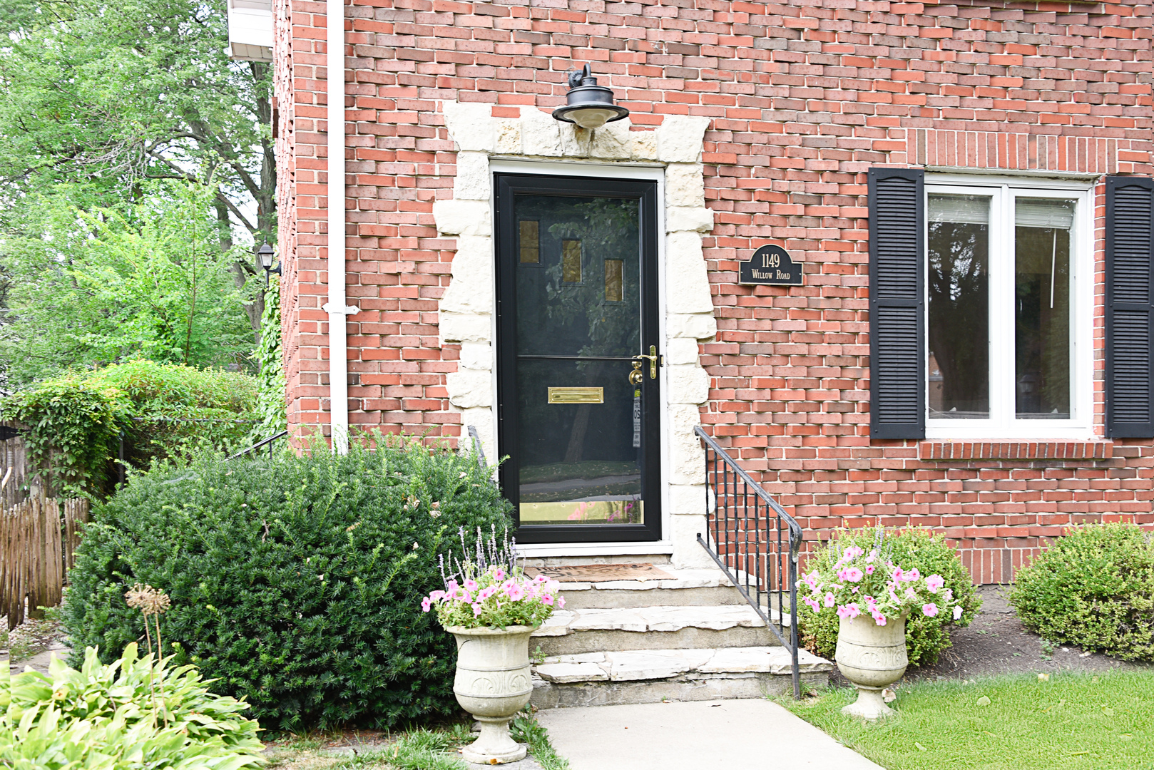 1149 Willow Road Winnetka, IL 60093 - Photo 3 of 37 a front view of a house with an outdoor space