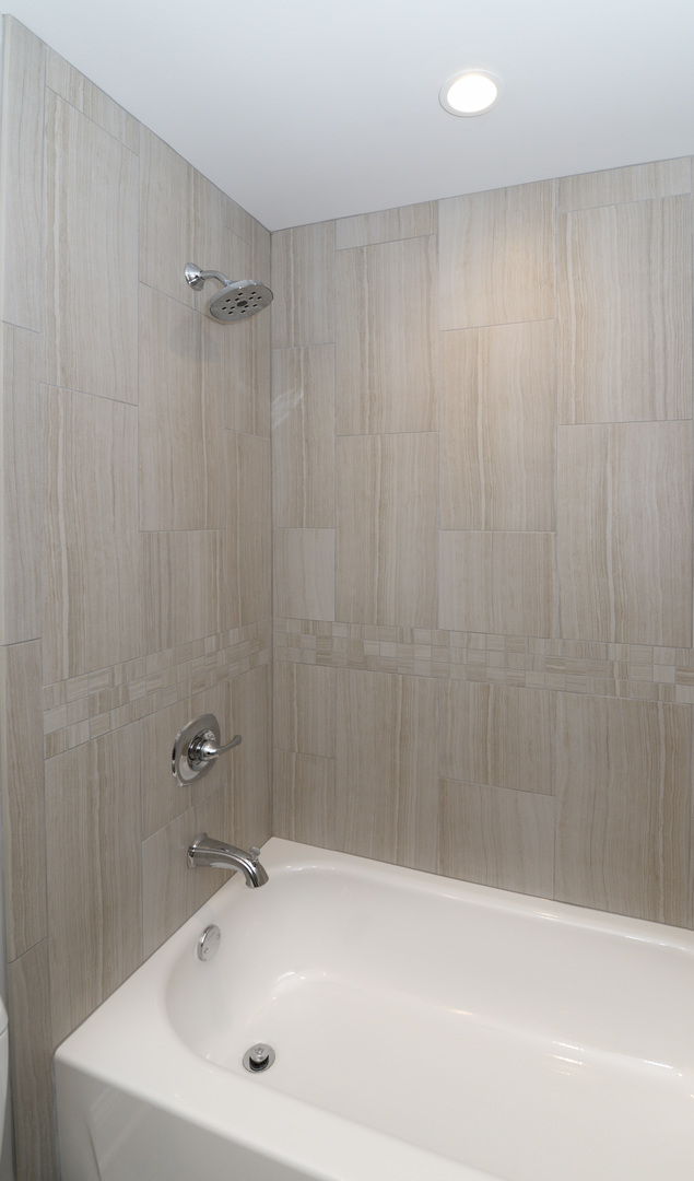1149 Willow Road Winnetka, IL 60093 - Photo 24 of 37 a bathroom with a sink a shower and a bathtub