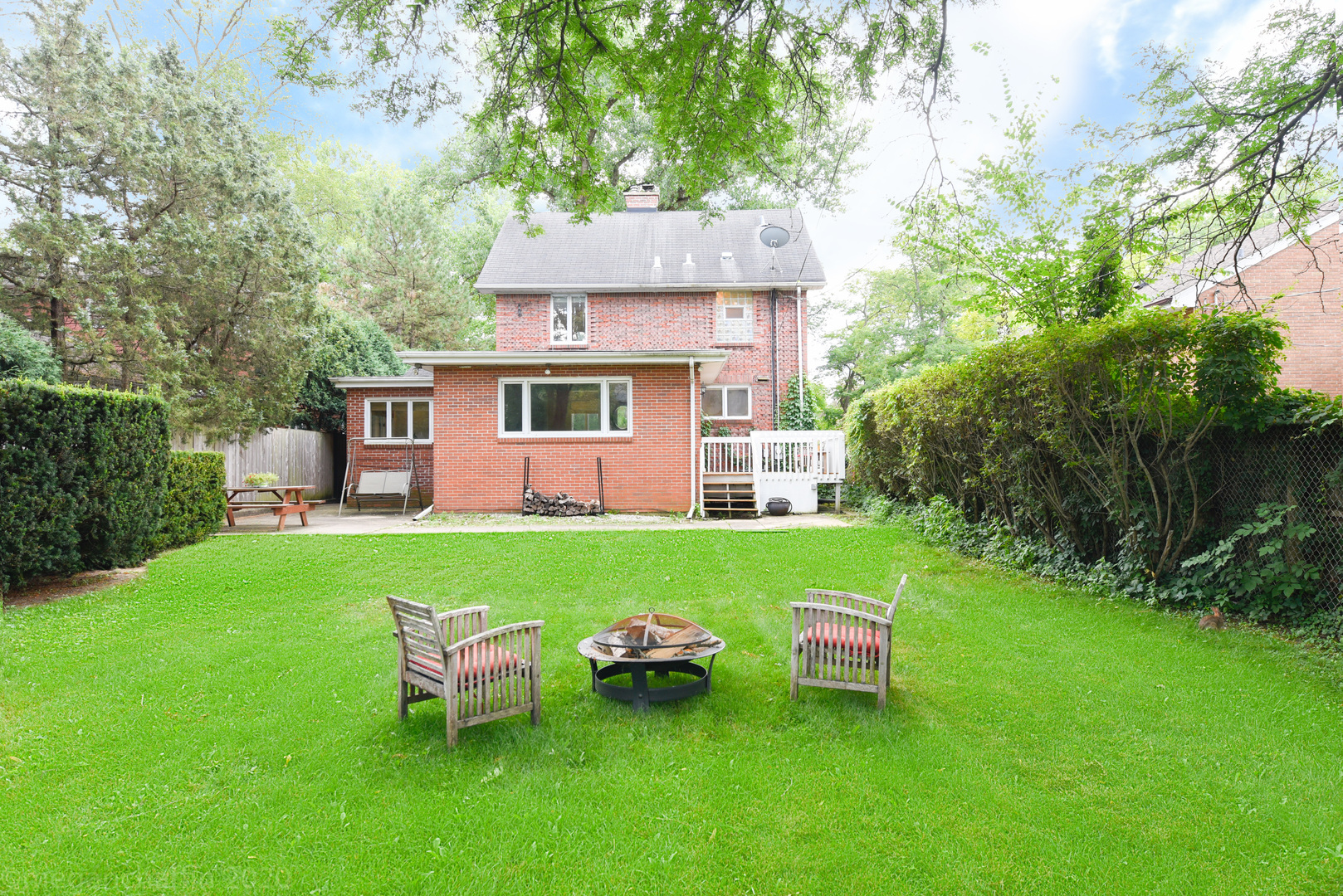 1149 Willow Road Winnetka, IL 60093 - Photo 29 of 37 a view of a house with a backyard and a patio