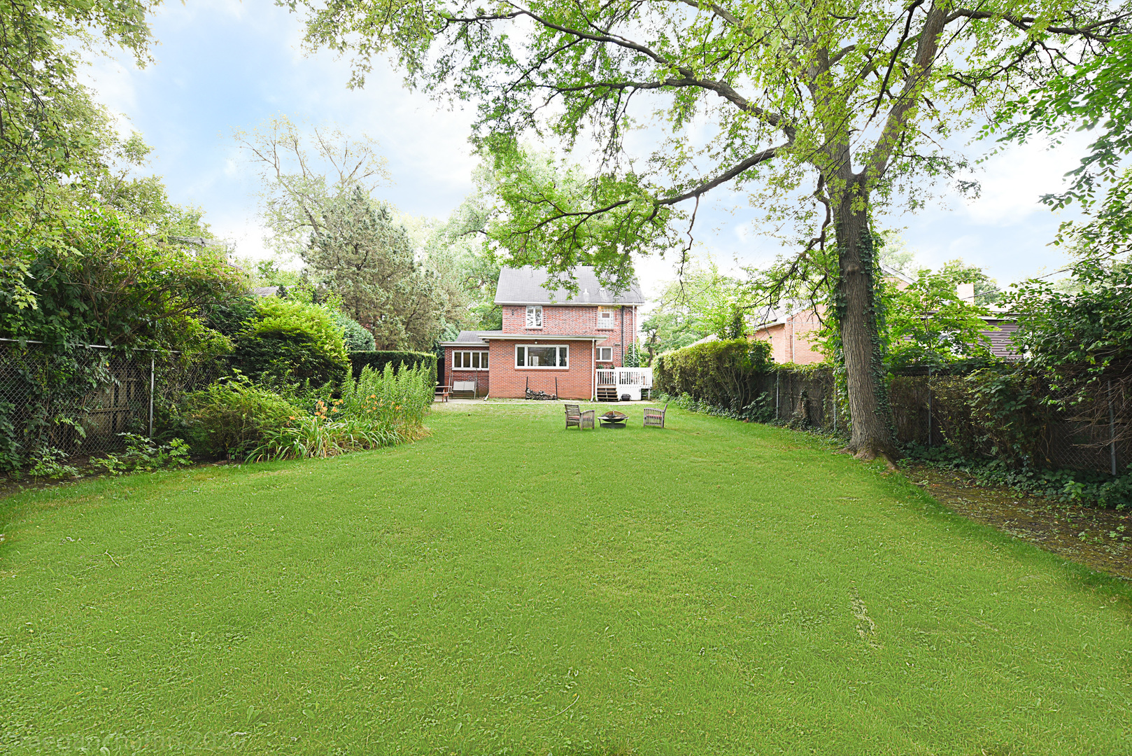 1149 Willow Road Winnetka, IL 60093 - Photo 30 of 37 a view of a house with backyard and a sitting area