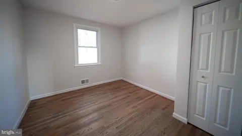 a view of room with wooden floor