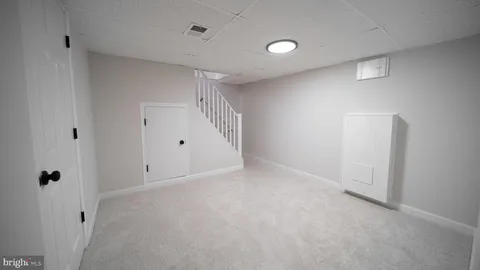 a living room with furniture and a walk in closet