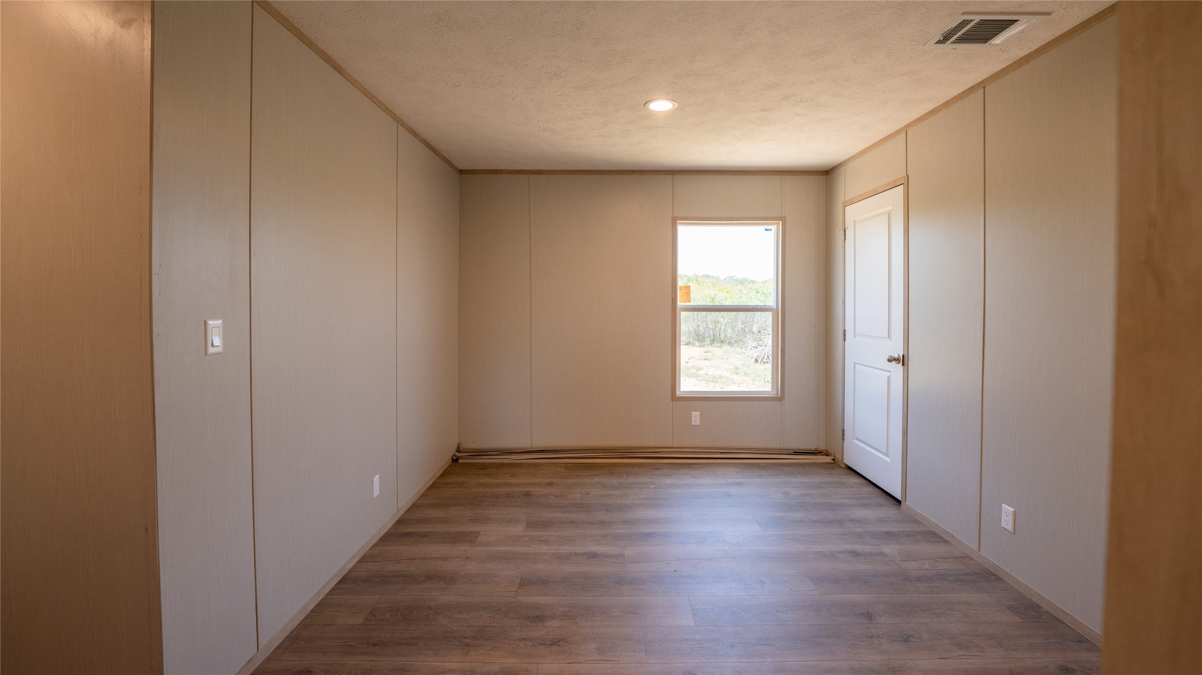 1145 Callihan Road Luling, TX 78648 - Photo 20 of 39 a view of hallway with window and wooden floor
