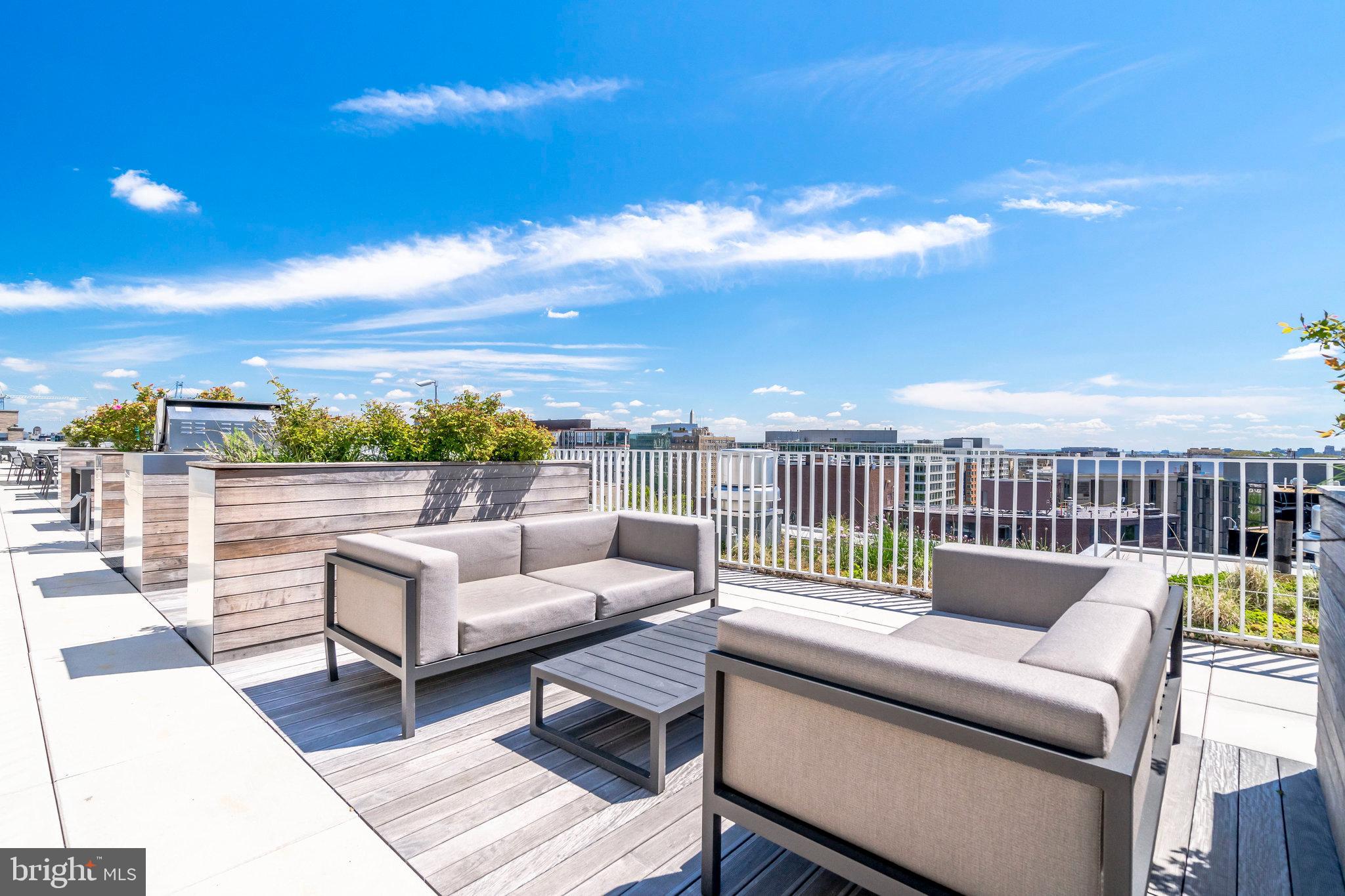 1111 24th Street Northwest, Unit 93 Washington, DC 20037 - Photo 26 of 26 a roof deck with couches and city view