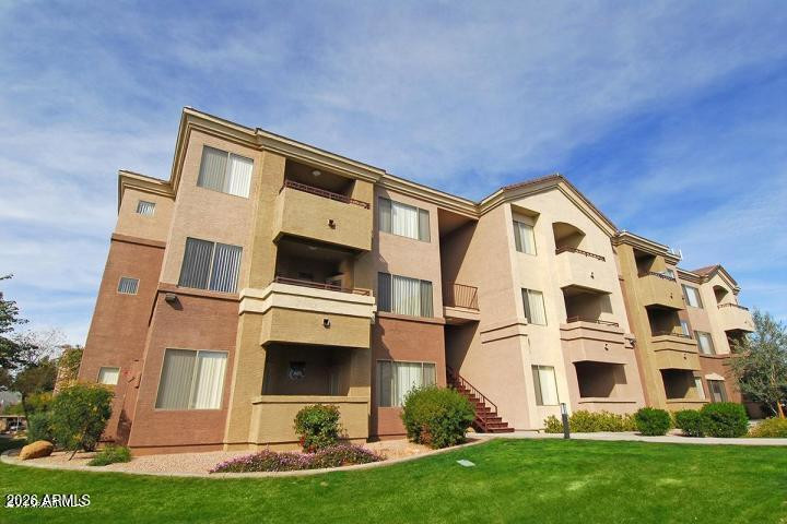 18416 North Cave Creek Road, Unit 2050 Phoenix, AZ 85032 - Photo 1 of 10 a front view of a house with a yard