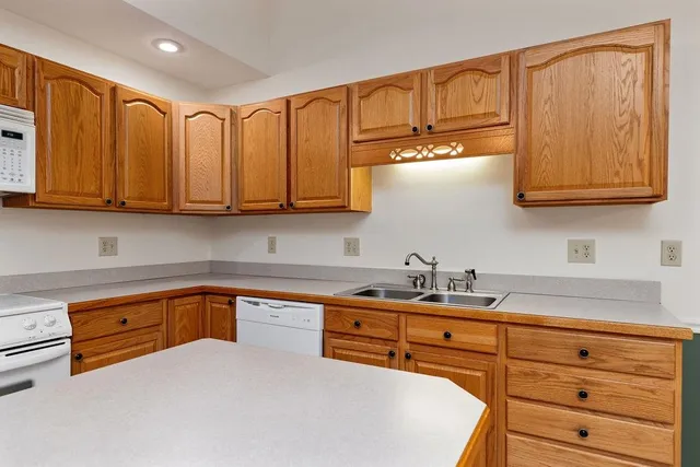 a kitchen with stainless steel appliances granite countertop a sink a stove and cabinets