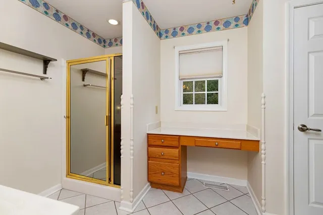 a house that has a bed and a window in it