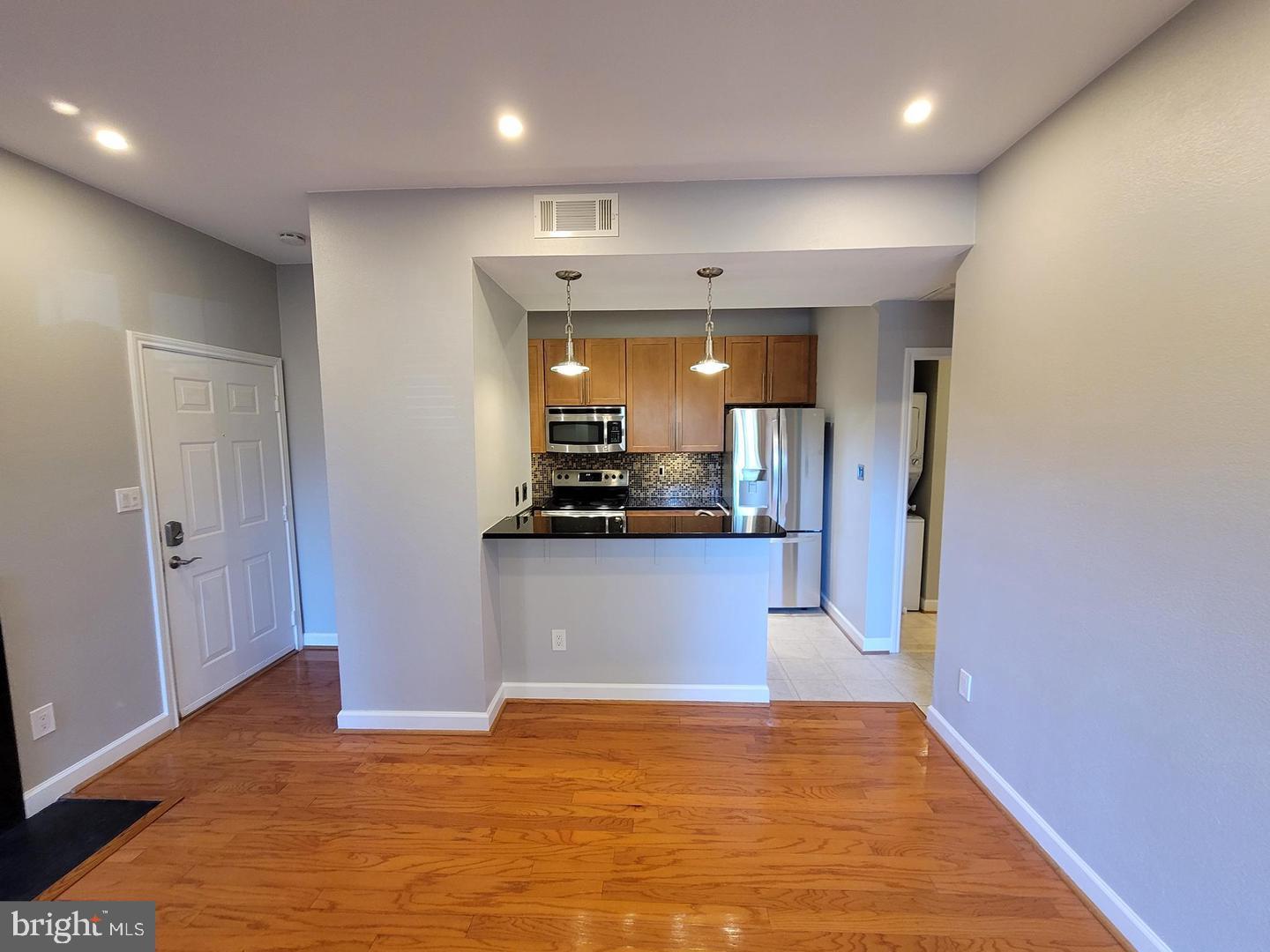 3908 Penderview Drive, Unit 608 Fairfax, VA 22033 - Photo 7 of 10 a view of kitchen and hall with wooden floor