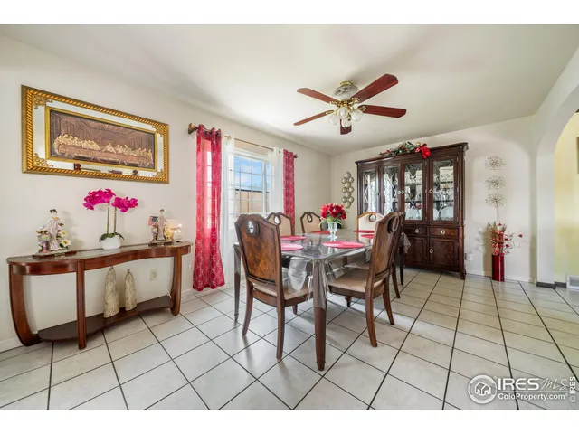a living room with furniture a dining table and a painting on the wall