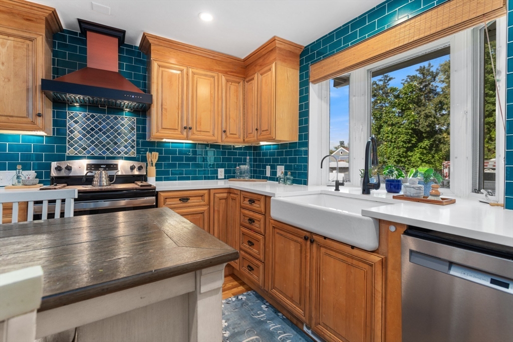 3 Webster Avenue Methuen, MA 01844 - Photo 4 of 34 a kitchen with stainless steel appliances granite countertop a sink a stove counter space and a window