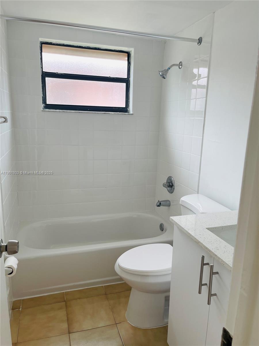 61 West 23rd Street, Unit 104 Hialeah, FL 33010 - Photo 6 of 17 a bathroom with a sink a toilet and shower