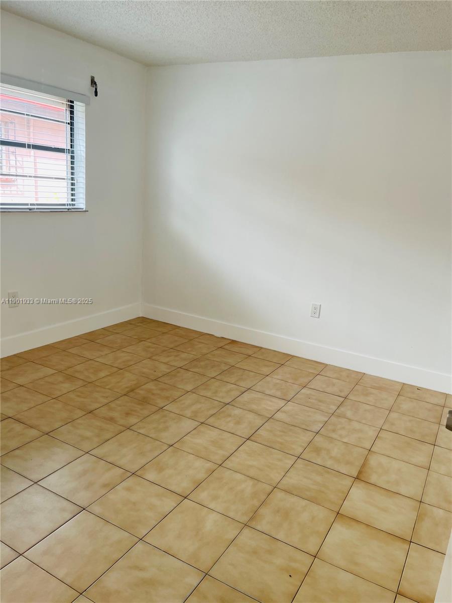 61 West 23rd Street, Unit 104 Hialeah, FL 33010 - Photo 8 of 17 a view of empty room