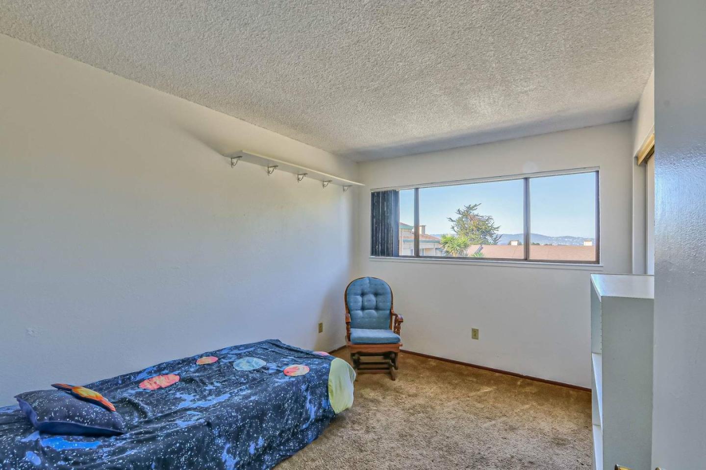1212 Trinity Avenue Seaside, CA 93955 - Photo 11 of 16 a bedroom with a bed and a window