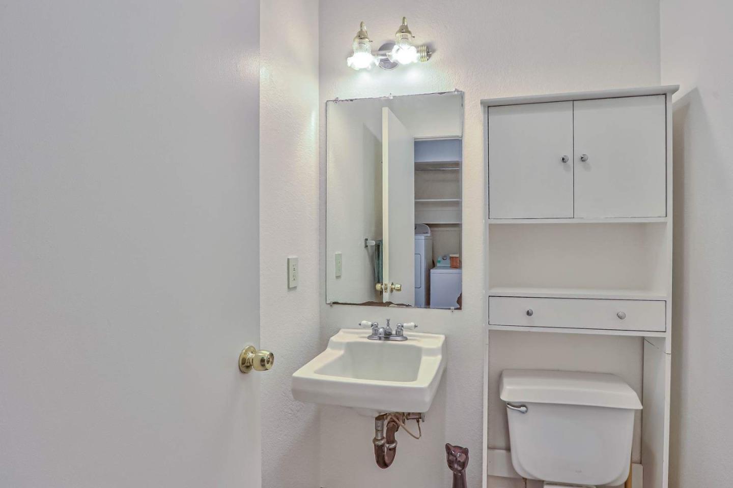 1212 Trinity Avenue Seaside, CA 93955 - Photo 12 of 16 a bathroom with a sink a toilet and mirror