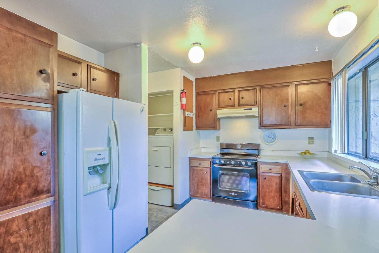 1212 Trinity Avenue Seaside, CA 93955 - Photo 14 of 16 a kitchen with stainless steel appliances granite countertop a refrigerator and a stove