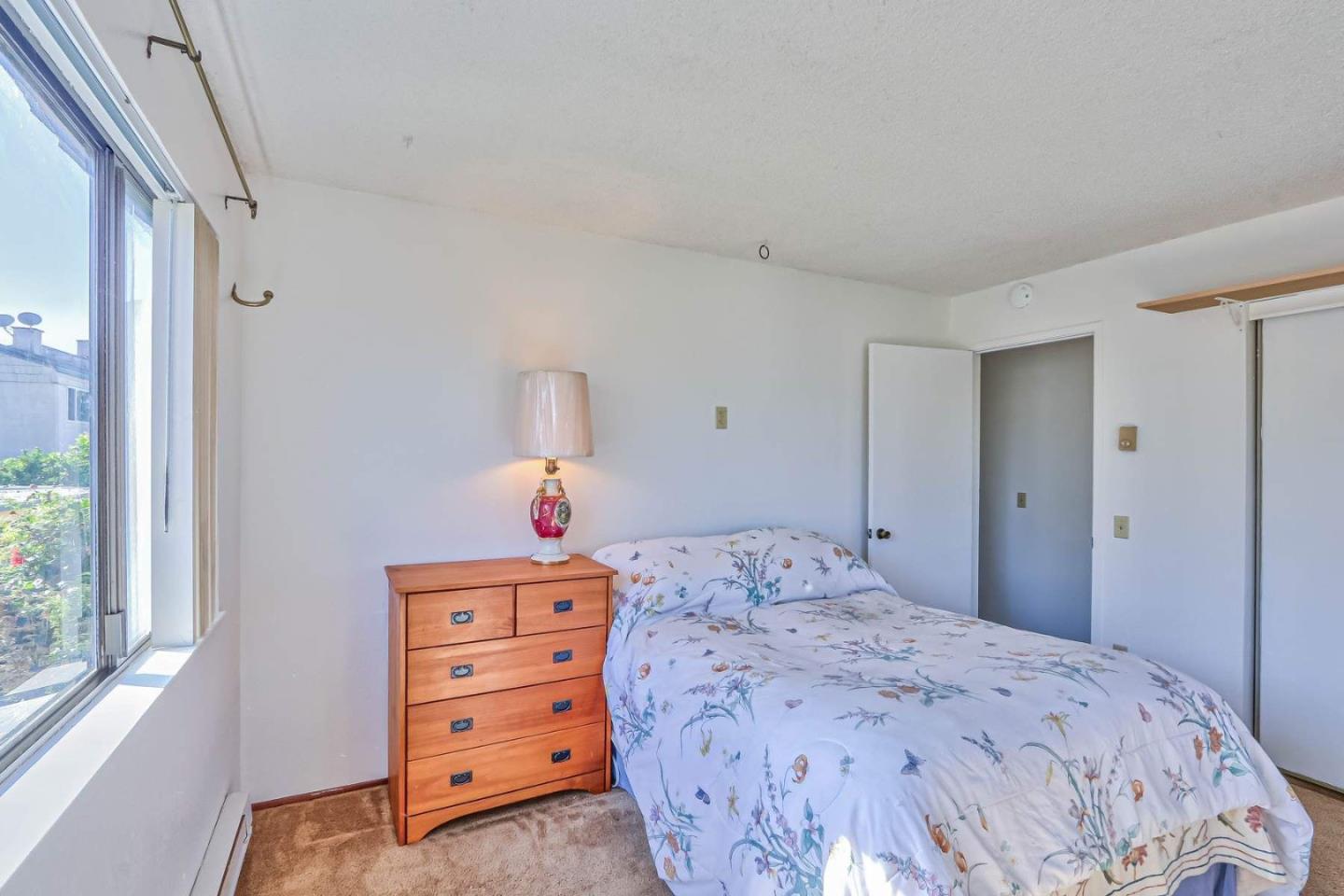 1212 Trinity Avenue Seaside, CA 93955 - Photo 8 of 16 a bedroom with a bed and a window