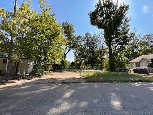 1005 West 8th Street Cameron, TX 76520 - Photo 12 of 16 a view of a house with a yard and large trees