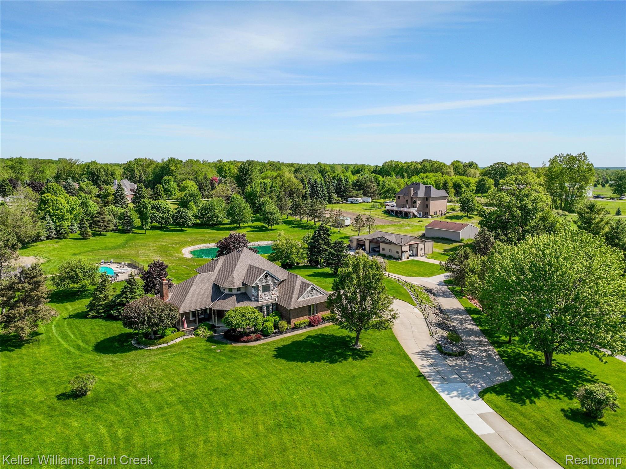 5813 36 Mile Road Romeo, MI 48065 - Photo 49 of 81 Expansive estate featuring a large main residence, detached outbuildings, a private pond, and an in-ground swimming pool