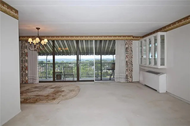 a view of an empty room with a fireplace