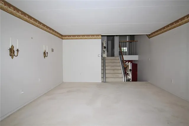 a view of a livingroom with furniture and floor to ceiling window