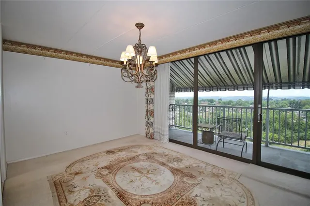 a kitchen with stainless steel appliances a sink a stove top oven a chimney cabinets and a counter top space