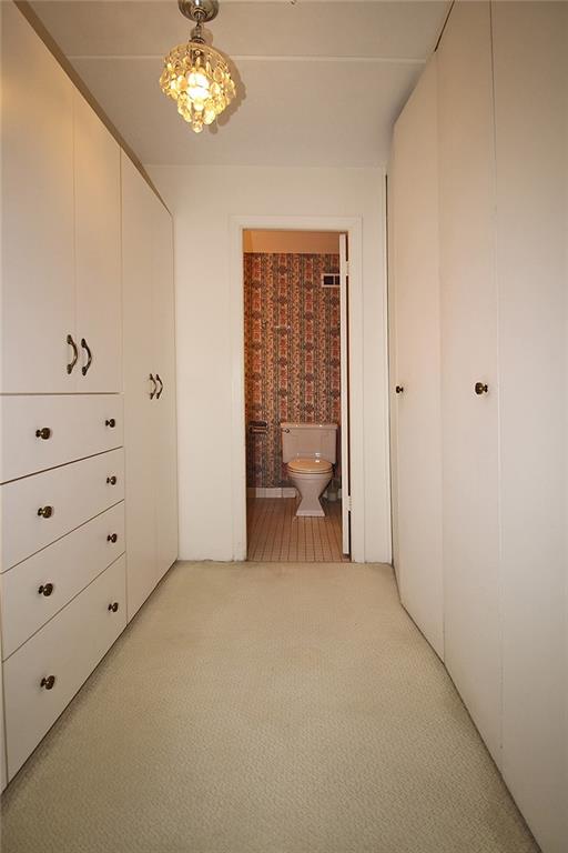 1150 Bower Hill Road, Unit 912A Pittsburgh, PA 15243 - Photo 28 of 39 a view of a bedroom with furniture and chandelier