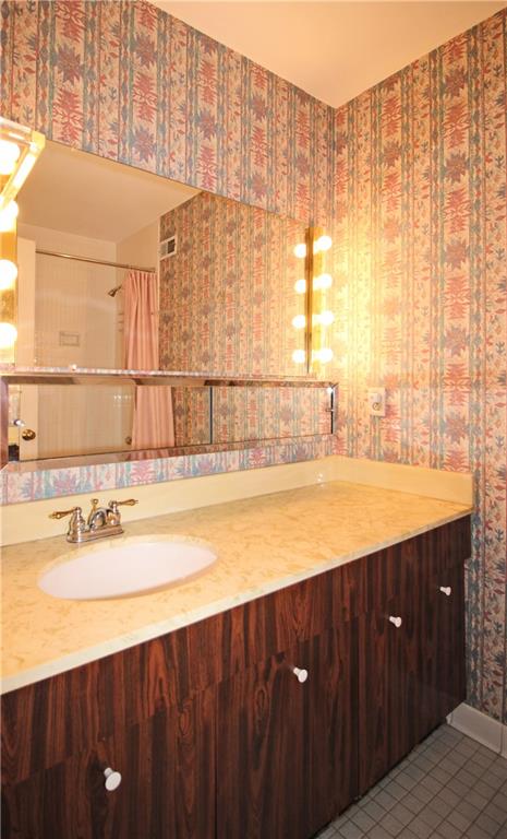 1150 Bower Hill Road, Unit 912A Pittsburgh, PA 15243 - Photo 30 of 39 a view of a bathroom with a sink and a window
