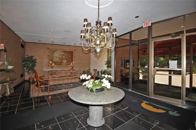 a view of a dining room with furniture and chandelier