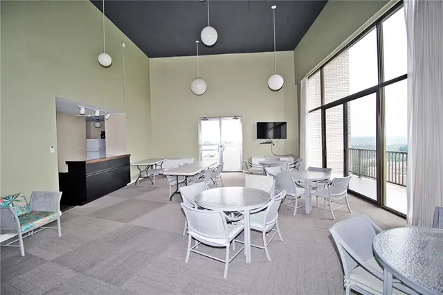 a dining room with furniture and a large window