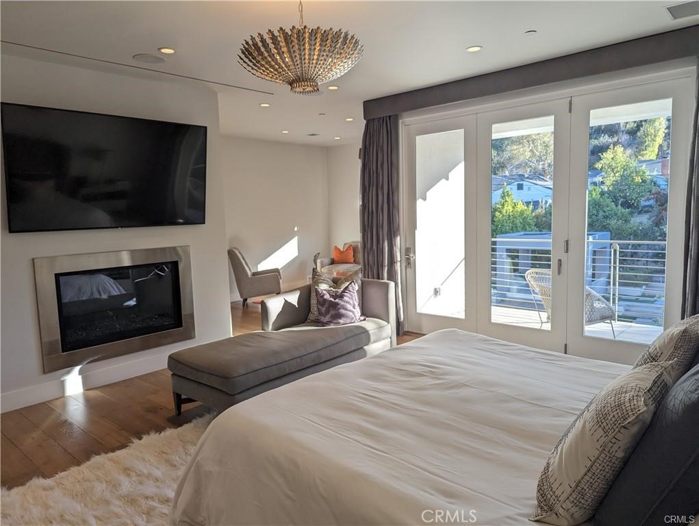 17950 Rancho Street Encino, CA 91316 - Photo 16 of 35 a bedroom with a large bed and a flat screen tv