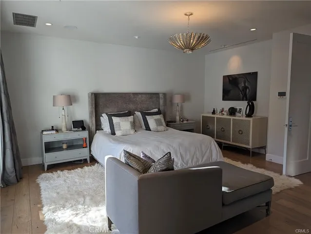 a bedroom with a bed and a television