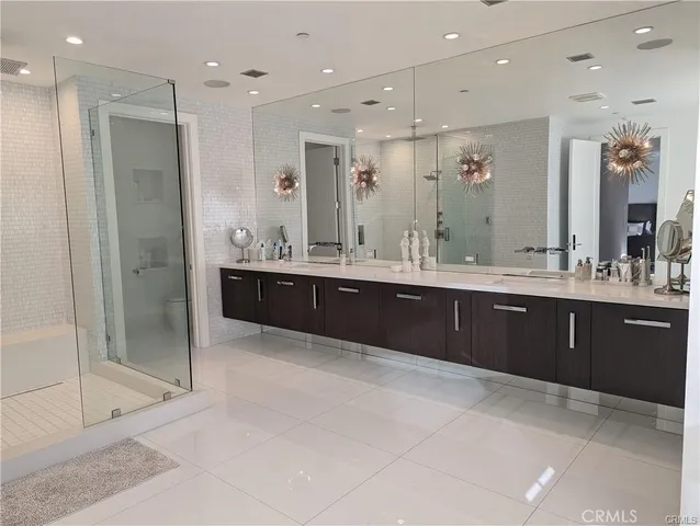 a bathroom with a mirror sink and double vanity