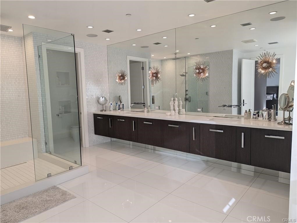 17950 Rancho Street Encino, CA 91316 - Photo 18 of 35 a bathroom with a mirror sink and double vanity